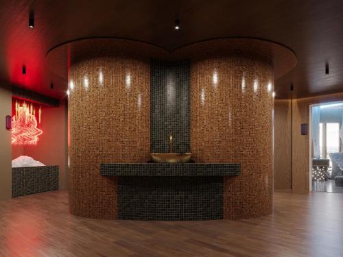 a bathroom with a sink in a brick wall at IDEA Collection by GINO Hotels in Tbilisi City
