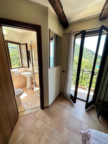 a bathroom with a toilet and a shower and a sink at B&B La Bastia in Scilla