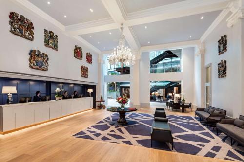 a lobby with a waiting area and a chandelier at The Edwardian Manchester, A Radisson Collection Hotel in Manchester