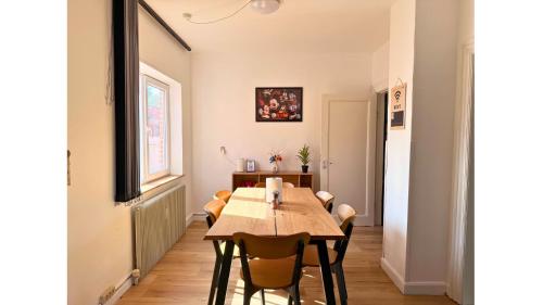 a dining room with a wooden table and chairs at Holeby Apartment 2 - next to Femern Puttgarden Lalandia Knuthenborg in Holeby