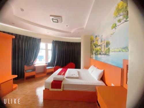 a bedroom with a bed and a painting on the wall at Hotel Nam Sơn in Hai Phong
