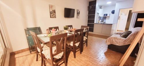 a dining table and chairs in a living room at Marina Nirvana vue sur l'eau in Le Grau-du-Roi