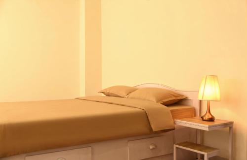 a bedroom with a bed and a lamp on a night stand at BasantapurRooms in Kathmandu