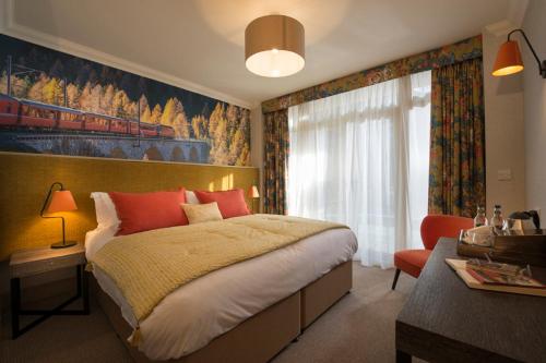 a bedroom with a large bed and a window at Harper's Steakhouse with Rooms, Haslemere in Haslemere