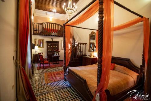 a bedroom with a canopy bed in a room at Ryad Salama in Fez