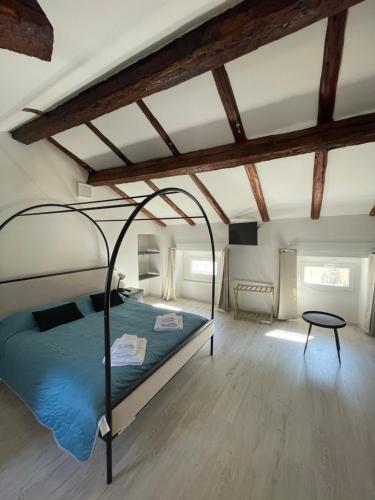 a bedroom with a canopy bed in a room with wooden ceilings at l'impronta in Gorizia