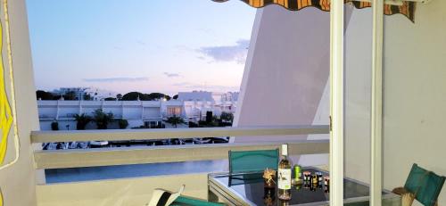 a balcony with a view of a city at Marina Nirvana vue sur l'eau in Le Grau-du-Roi