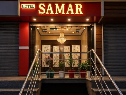 a store front with potted plants in front of it at Hotel Samar in Srinagar