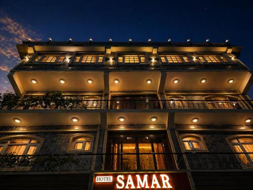 a tall building with a sign in front of it at Hotel Samar in Srinagar