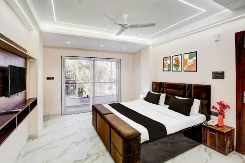 a bedroom with a large bed and a television at Super Collection O Ganeshpuri Indore in Indore