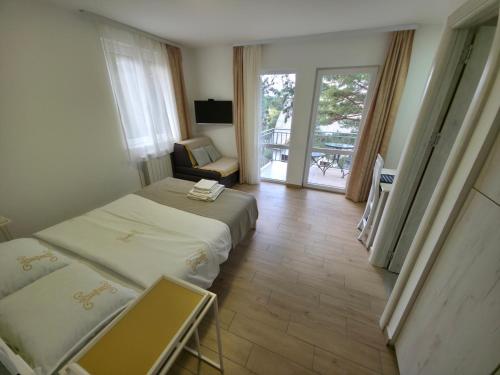 a hotel room with two beds and a balcony at Markov Konak in Divčibare