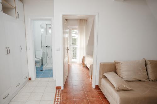a living room with a couch and a bathroom at Markov Konak in Divčibare