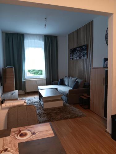 a living room with a couch and a table at Gemütliche Ferienwohnung in Bottrop