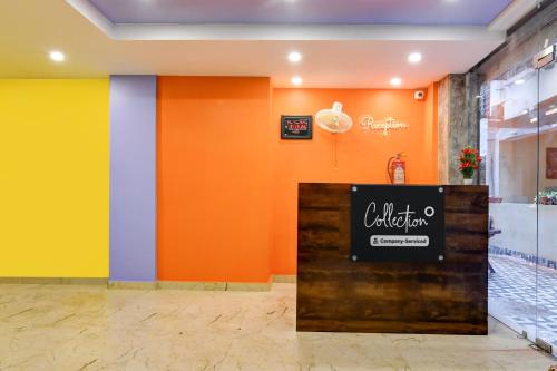 a restaurant with orange and yellow walls and a sign at Super Collection O New Town Near OM Sweets Formerly Shiva Inn in kolkata