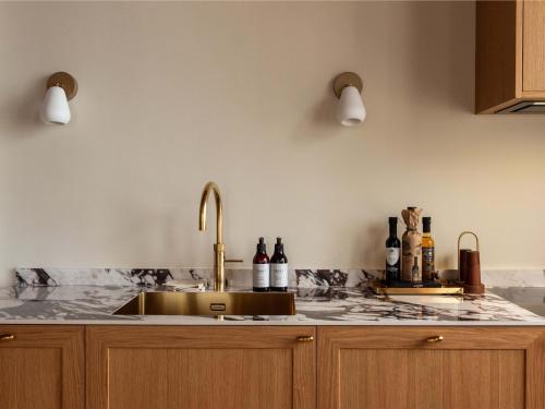 a kitchen with a sink and a counter top at Four Suites Copenhagen - Boutique Townhouse Suites in Copenhagen