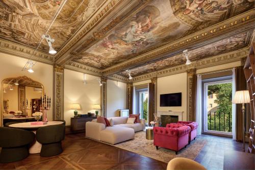a living room with a ceiling with a painting on it at Palazzo Massimo Boutique Piazza Venezia in Rome
