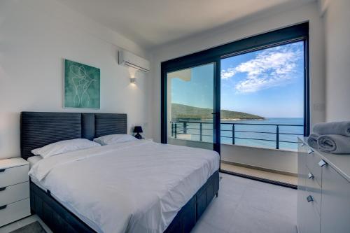 a bedroom with a bed and a view of the ocean at Beach Apartments in Ulcinj