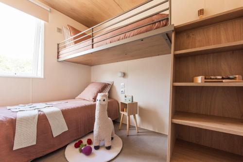 a small bedroom with a bed and bunk beds at CAMPING AZU'RIVAGE in Azur