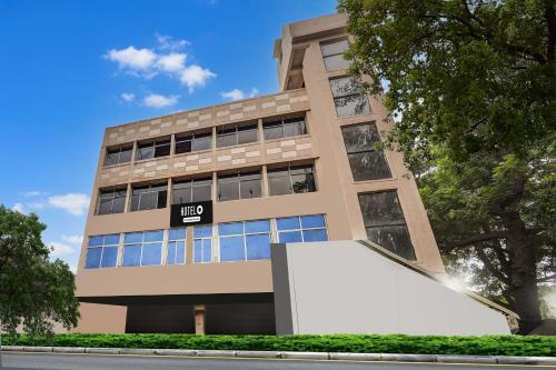 a building with a large white sign in front of it at Hotel O Jamalpur Ahmedabad Formerly Hotel Peace in Ahmedabad