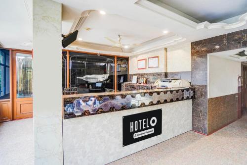 a restaurant counter with a hotel sign on it at Hotel O Jamalpur Ahmedabad Formerly Hotel Peace in Ahmedabad