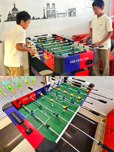a boy standing next to a foosball table at Good2Stay Budget Hotel l Lift l Coway Water l WIFI6 l Laundromat in Malacca