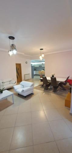 a living room with a white couch and chairs at Sofia villa in Elaiokhórion