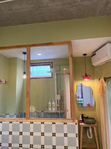 a bathroom with a mirror and a sink at Tiny bright house Autum space in Danang