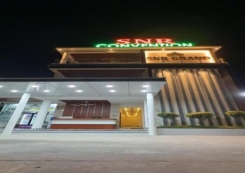 a building with a neon sign in front of it at SNR GRAND in Narasaraopet