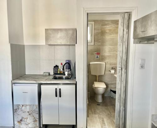 a small bathroom with a sink and a toilet at Studios Zafiri in Naxos Chora