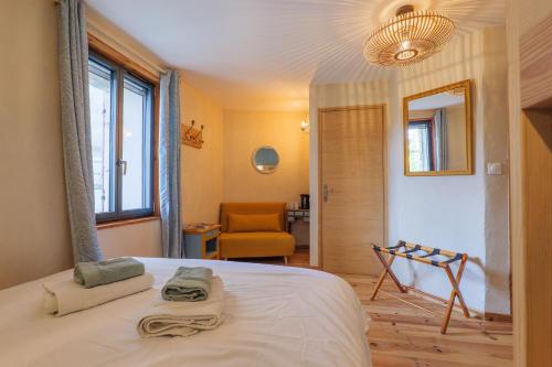 a bedroom with a bed with two towels on it at Chambres D’hôtes - Les Agrions in Saint-Remèze