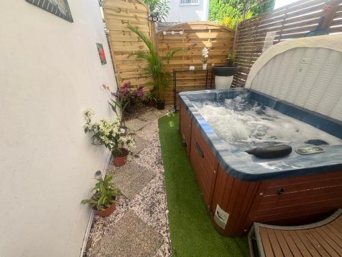 a hot tub in the middle of a garden at Le Cataleya - Résidence Terre et Truffes in Le Lamentin