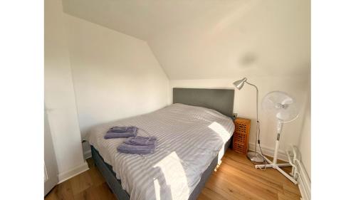 a bedroom with a bed with towels on it at Holeby Apartment 1 - next to Femern Puttgarden Lalandia Knuthenborg in Holeby