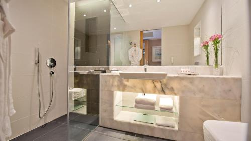 a bathroom with a sink and a shower at Akra V - Access to Akra Antalya in Antalya