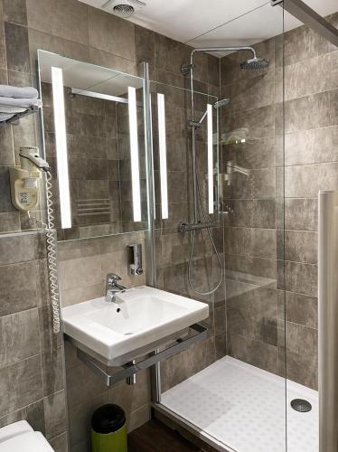 a bathroom with a sink and a shower at Le Clos De Mutigny in La Chaussée-sur-Marne