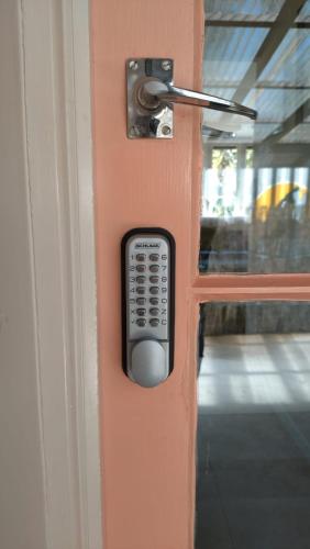 a door with a remote control sticking out of it at Thyme On The Terrace in Te Anau