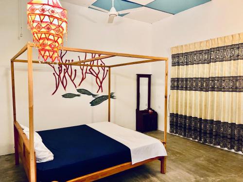 a bedroom with a bed with a basketball net at Paradise Bay Hotel in Arugam Bay