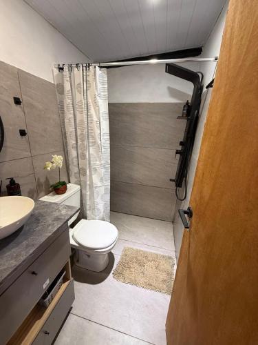 a small bathroom with a toilet and a sink at Refugio El Benja in Villa Salto Encantado