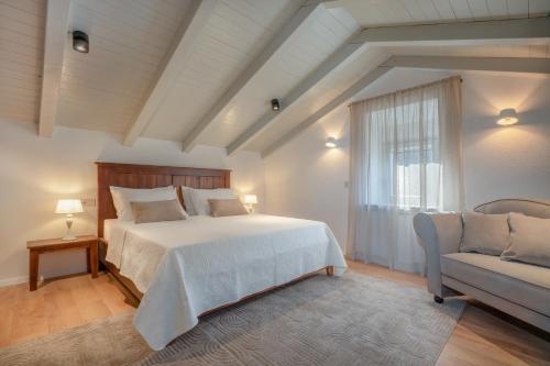 a bedroom with a large bed and a couch at Villa Rocco in Kozljak