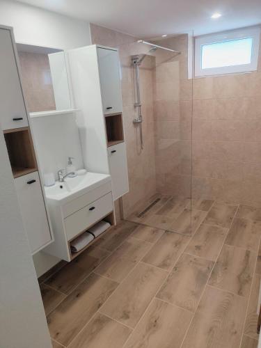 a bathroom with a sink and a shower at Dom priamo pri rieke in Opatovce nad Nitrou