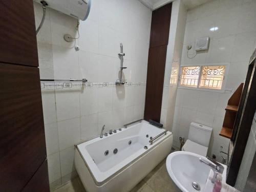 a bathroom with a bath tub and a sink at The Nest in Aso