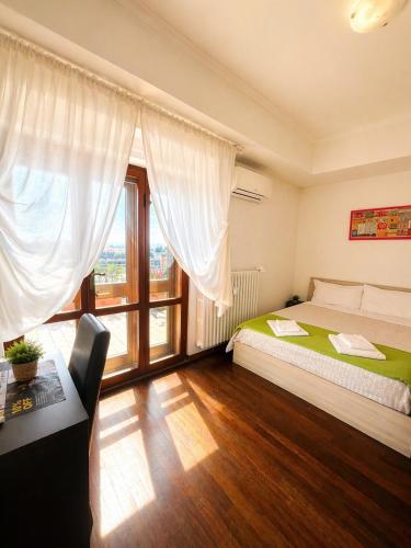 a bedroom with a bed and a large window at B&B Colombo in Pisa