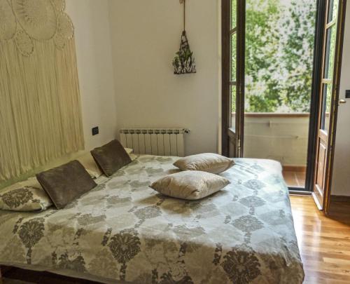 a bedroom with a bed with pillows on it at Nido di Luna in Mulazzo