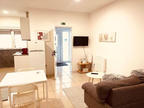 a living room with a couch and a table at Casa de Casarelhos - AC - BBQ - "Gerês" in Geres