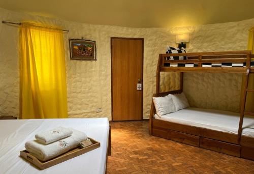 a bedroom with a bunk bed with towels on it at Midnite Inn in Panglao Island