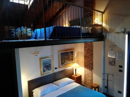 a bedroom with a bed under a balcony at B&B Il Girasole in Cuneo