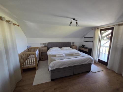 a bedroom with a large bed and a window at Kraljeva Kruna - kuća za odmor in Koprivnica