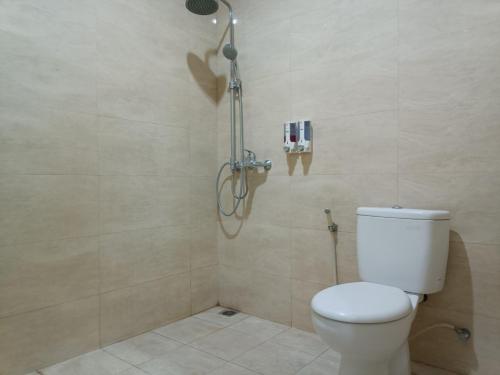 a bathroom with a toilet and a shower at The Cabin Hotel Wirobrajan in Yogyakarta