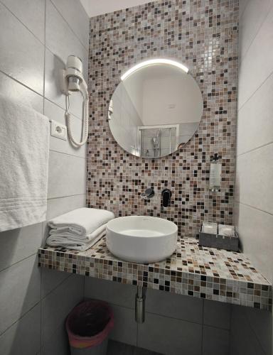 a bathroom with a sink and a mirror at Hotel PRINCIPE AMEDEO in Rome