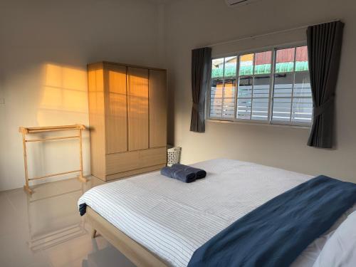 a bed in a room with a window and a bed sidx sidx sidx at Tiny Home - Hin Lad Waterfall in Nathon Bay