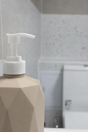 a white tooth brush sitting on top of a box at Skala Hostel in Almaty